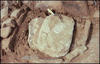 Slab-lined corner hearth in Room 8, Area 1 with overturned metate and slab in fill (SL-YJ-JC-020)